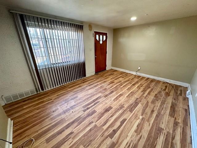 entrance foyer featuring baseboards and wood finished floors