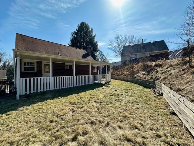 exterior space with a lawn and fence