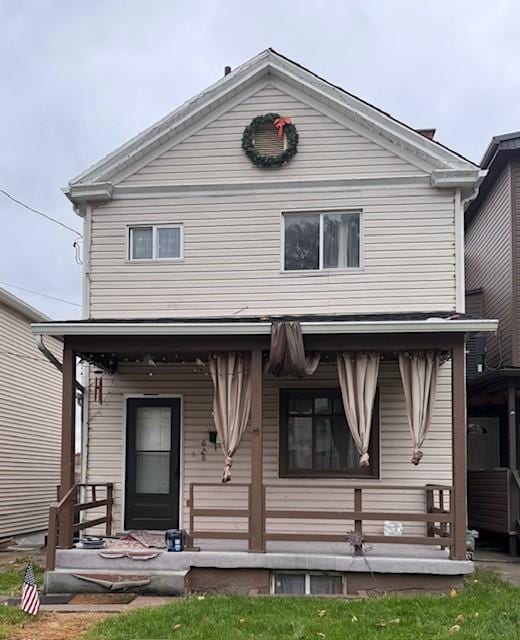 rear view of house featuring covered porch