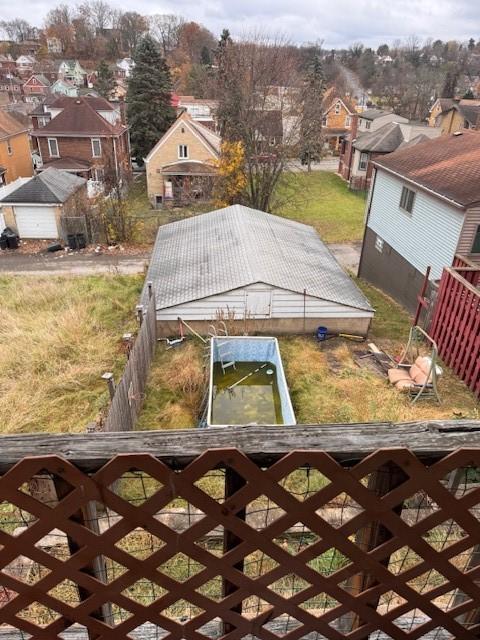 view of yard with a dock, a residential view, and fence