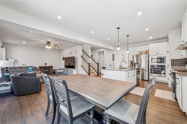 334 Crossing Dr, North Strabane, PA 15330 - dining room featuring stairway, a ceiling fan, wood finished floors, and recessed lighting