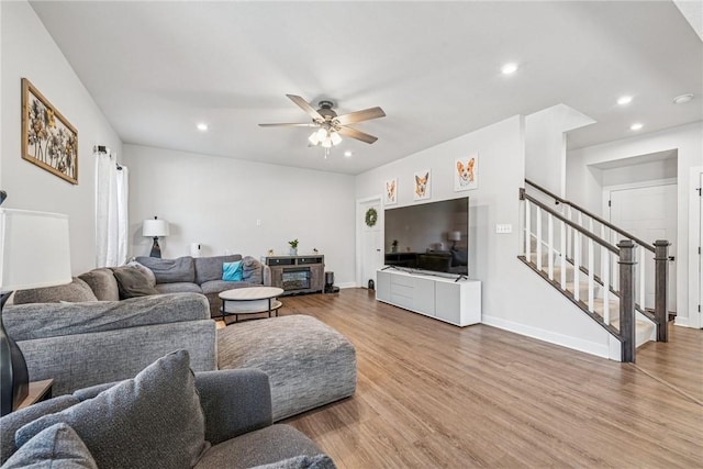 living room with recessed lighting, wood finished floors, a ceiling fan, baseboards, and stairway