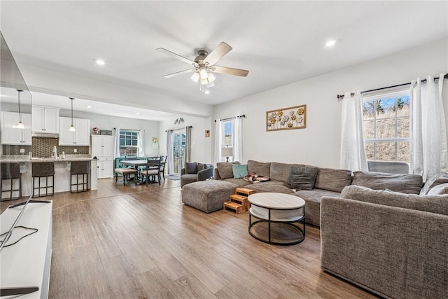 living room featuring a ceiling fan, recessed lighting, and wood finished floors