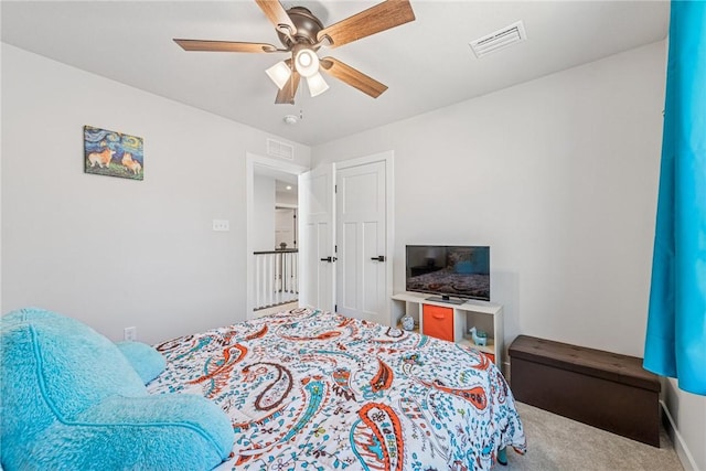 bedroom with carpet, visible vents, and ceiling fan