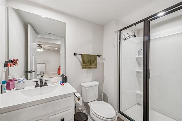 bathroom with visible vents, a ceiling fan, toilet, vanity, and a shower stall