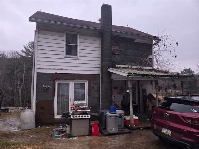 rear view of house featuring a chimney