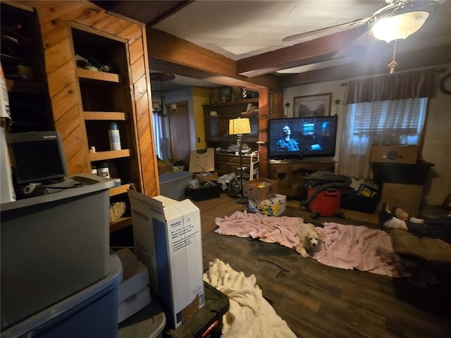 living room featuring beam ceiling and wood finished floors