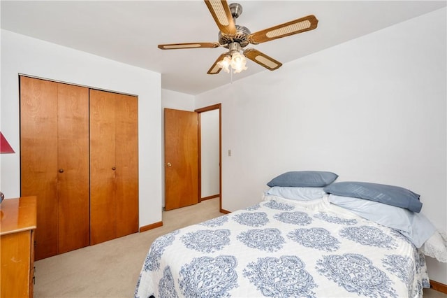 bedroom with light carpet, a closet, a ceiling fan, and baseboards