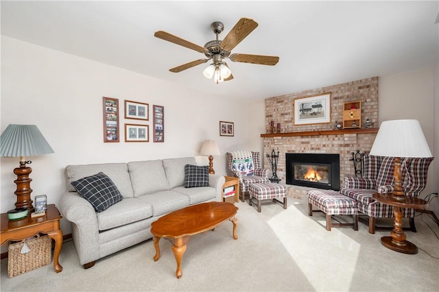 carpeted living room featuring a brick fireplace and a ceiling fan