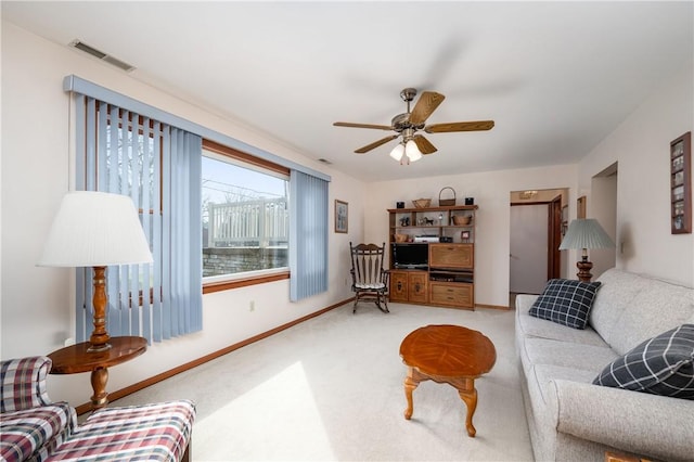 living room featuring baseboards, carpet, visible vents, and a ceiling fan