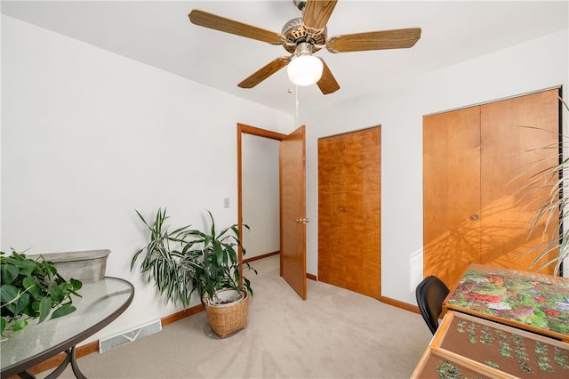 office space with carpet floors, visible vents, and baseboards