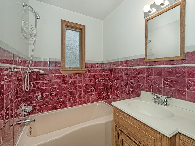 full bath with tile walls, a wainscoted wall, and vanity