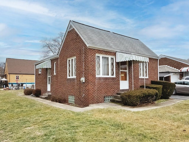 view of property exterior with a shingled roof, a lawn, and brick siding