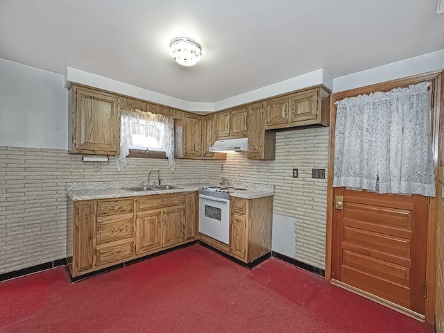 kitchen with light countertops, ventilation hood, white gas range, and a sink