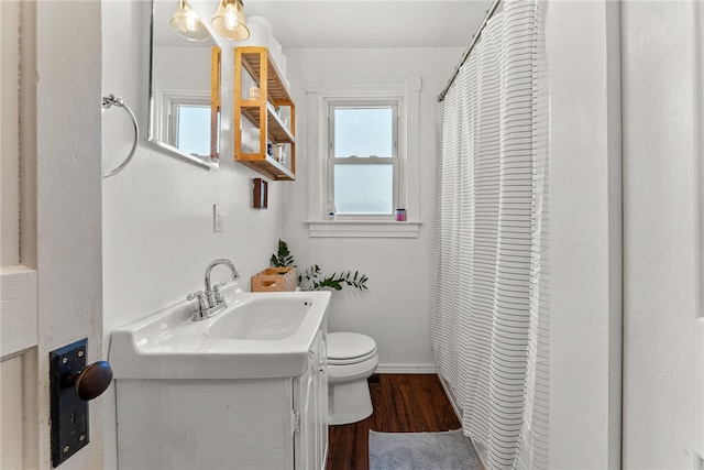 full bath featuring baseboards, vanity, toilet, and wood finished floors