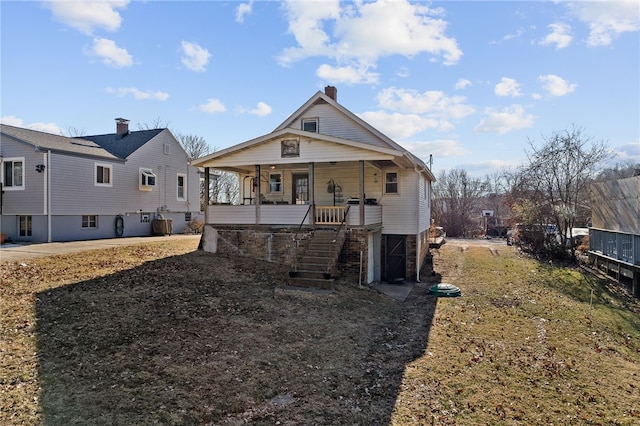 view of front facade featuring stairs, covered porch, and cooling unit