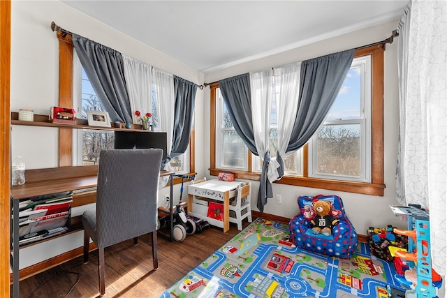 recreation room featuring baseboards and wood finished floors