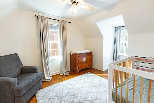 bedroom featuring a ceiling fan, vaulted ceiling, and wood finished floors