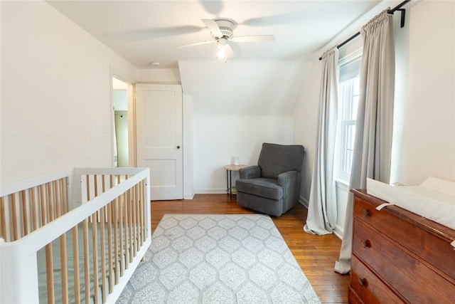 bedroom with a ceiling fan, baseboards, and wood finished floors