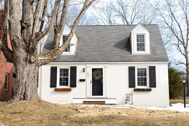 cape cod home with brick siding