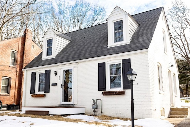 new england style home with brick siding