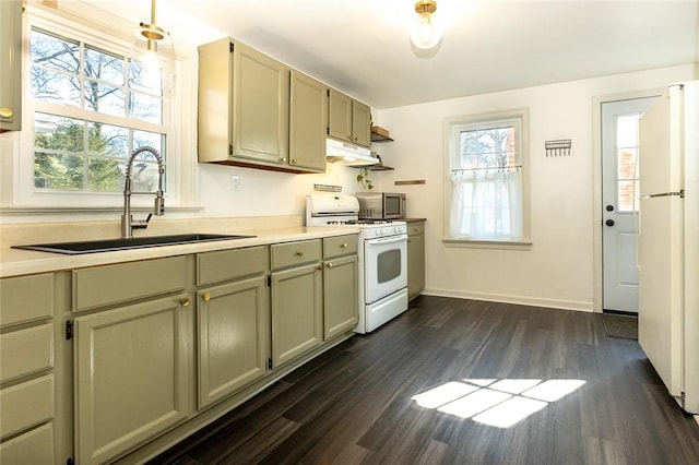 kitchen featuring light countertops, dark wood-type flooring, a sink, white appliances, and under cabinet range hood