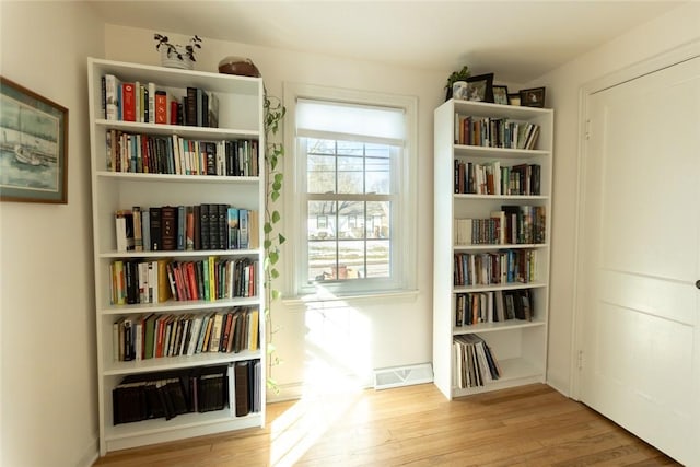 sitting room with visible vents and wood finished floors