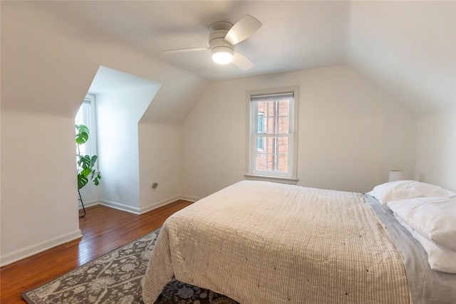 bedroom featuring lofted ceiling, wood finished floors, a ceiling fan, and baseboards