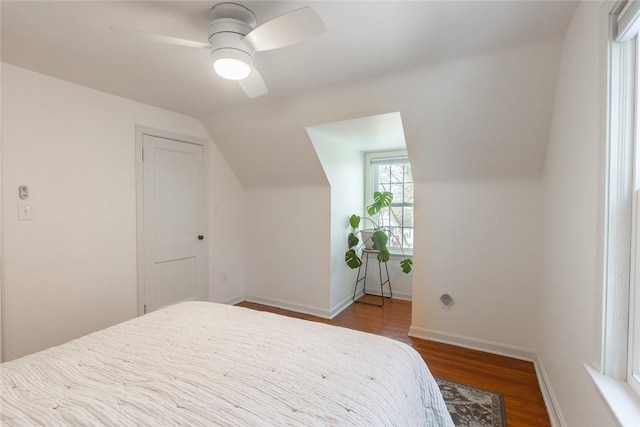 bedroom featuring vaulted ceiling, ceiling fan, wood finished floors, and baseboards