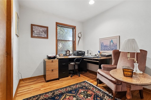 office space with light wood-style flooring and baseboards