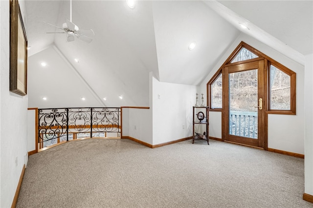 bonus room with vaulted ceiling, carpet floors, a ceiling fan, and baseboards