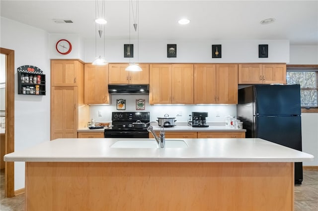 kitchen with light countertops, a kitchen island with sink, a sink, under cabinet range hood, and black appliances