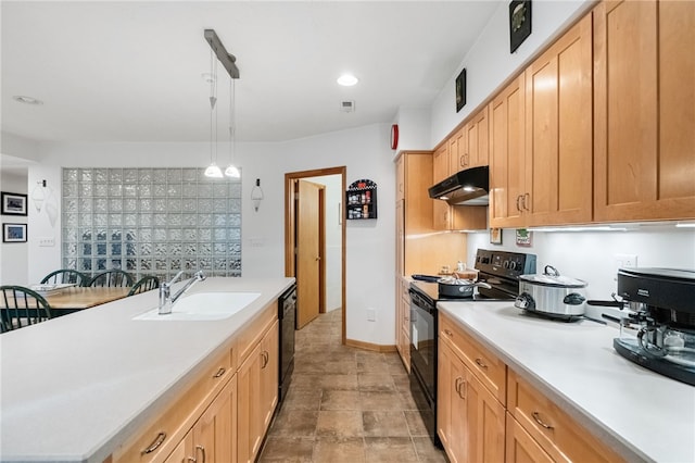 kitchen with under cabinet range hood, a sink, light countertops, black appliances, and decorative light fixtures