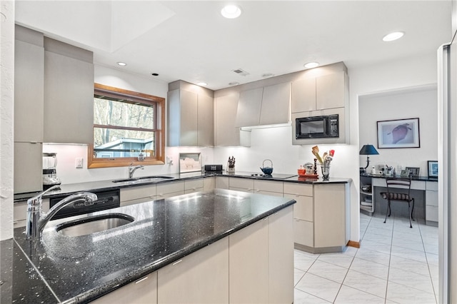 kitchen with dark stone counters, a sink, black appliances, and recessed lighting