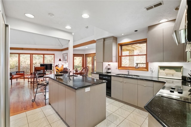 kitchen with black dishwasher, light tile patterned floors, visible vents, a sink, and dark stone countertops