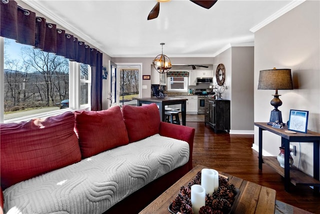 living area with crown molding, dark wood-type flooring, ceiling fan, and baseboards