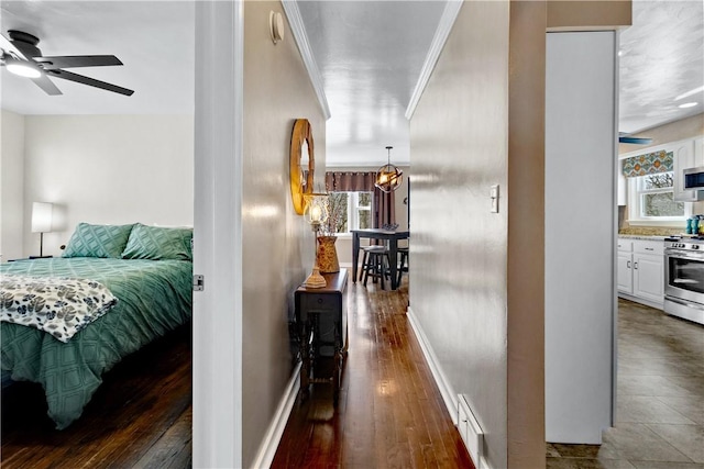 interior space with visible vents, baseboards, crown molding, and wood finished floors