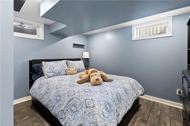 bedroom featuring dark wood finished floors and baseboards