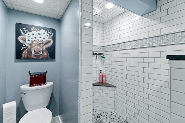 full bath featuring a tile shower and toilet