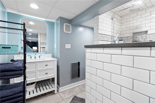 bathroom featuring tile patterned flooring, visible vents, vanity, and a walk in shower