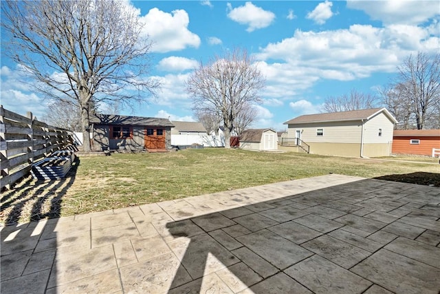 view of yard featuring a patio area, an outdoor structure, and a fenced backyard