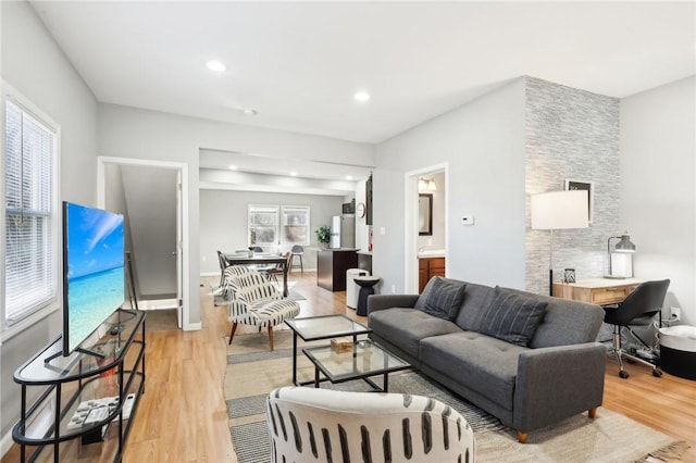 living area with light wood-style floors and recessed lighting