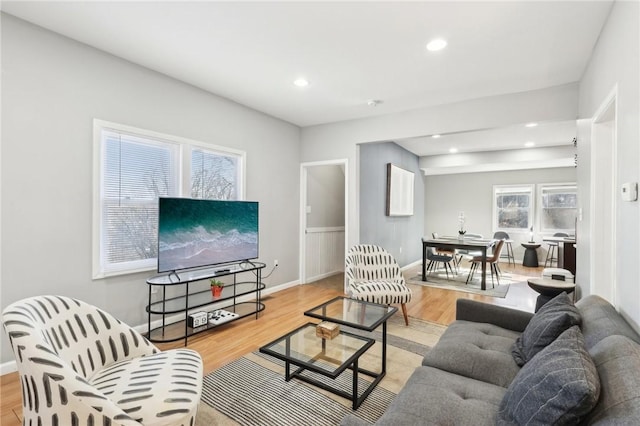 living room with recessed lighting, light wood-style flooring, and baseboards