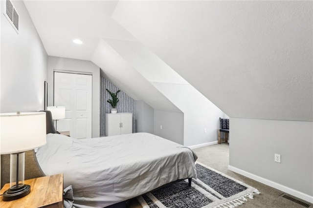 bedroom with lofted ceiling, carpet, visible vents, and baseboards