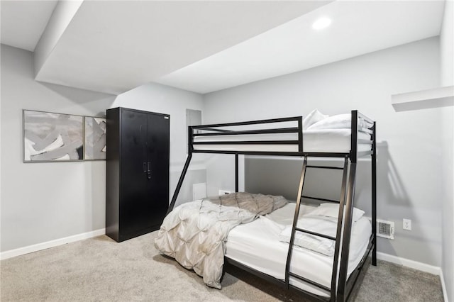 bedroom with carpet floors, visible vents, and baseboards