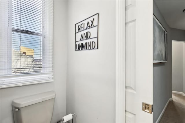 bathroom featuring toilet and baseboards