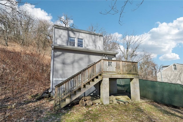 view of side of property featuring a deck and stairs