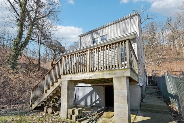 back of house featuring fence, stairway, and a wooden deck