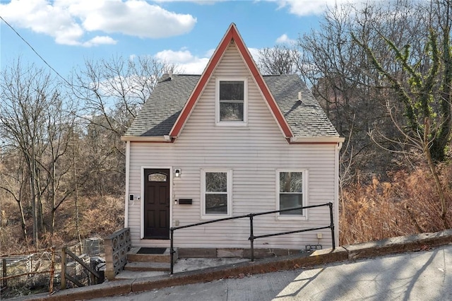 view of front of home featuring roof with shingles