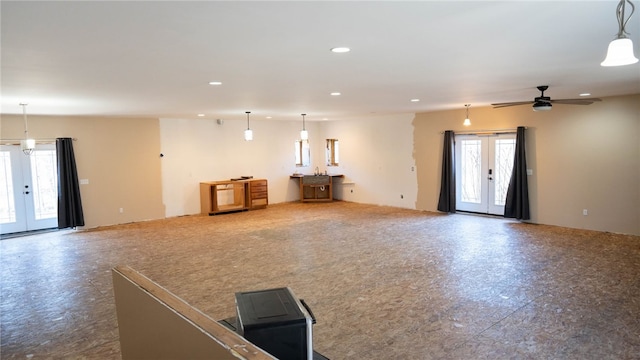 unfurnished living room featuring recessed lighting, a ceiling fan, and french doors